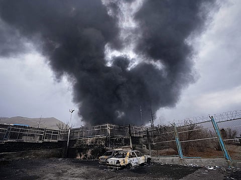 A thick plume of smoke rises from an oil storage facility hit by a US-Israeli strike in Tehran, Iran.
