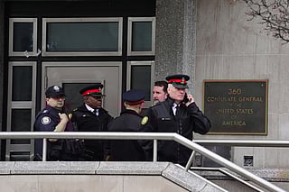 Toronto police officers investigate outside the U.S. consulate in Toronto on Tuesday March 10, 2026.  