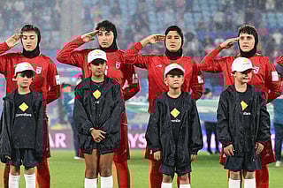 Iran players salute during their national anthem ahead of the Women's Asian Cup soccer match between Iran and the Philippines in Robina, Australia, Sunday, March 8, 2026. (Dave Hunt/AAP Image via AP)