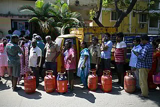 People queue to buy liquefied petroleum gas (LPG) cylinders for domestic use, at a gas agency office in Chennai on March 11, 2026.