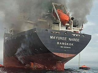 This handout photo taken on March 11, 2026 and released by the Royal Thai Navy shows smoke rising from the Thai bulk carrier 'Mayuree Naree' near the Strait of Hormuz after an attack. 