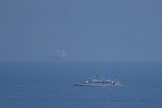 A UAE navy ship patrols the Strait of Hormuz as seen from Mina Al Fajer, United Arab Emirates, Wednesday, March 11, 2026. (AP Photo/Altaf Qadri)