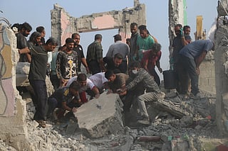 Rescue workers and residents search through the rubble in the aftermath of a strike on a girls' elementary school in Minab, Iran, Saturday, Feb. 28, 2026. (Abbas Zakeri/Mehr News Agency via AP)