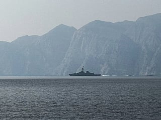 A navy vessel is seen sailing in the Strait of Hormuz, a vital waterway through which much of the world's oil and gas passes on 