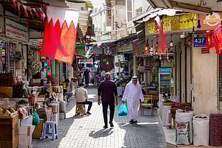 People walk along an alley at a bazaar in Bahrain's capital Manama on March 11, 2026.