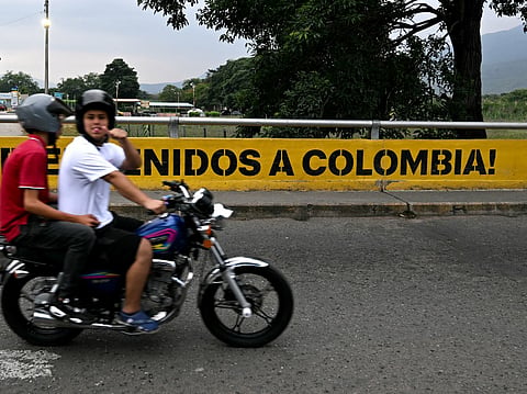 A man riding a motorbike gestures as he crosses the Colombia-Venezuela border at the Simon Bolivar International Bridge on the outskirts of Cucuta, Colombia 