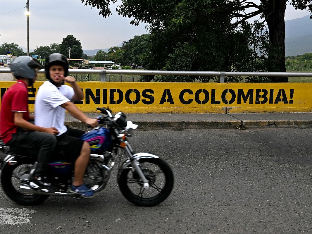 A man riding a motorbike gestures as he crosses the Colombia-Venezuela border at the Simon Bolivar International Bridge on the outskirts of Cucuta, Colombia 