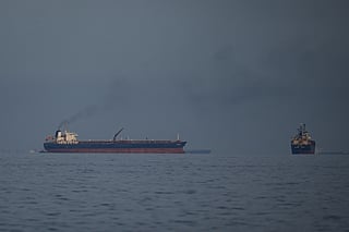 Oil tankers and cargo ships line up in the Strait of Hormuz as seen from Khor Fakkan, United Arab Emirates, Wednesday, March 11, 2026. 
