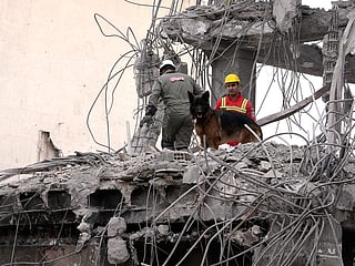 Firefighters work at a residential building damaged Sunday during the US-Israeli air campaign in Tehran, Iran, on Thursday, March 12, 2026. 
