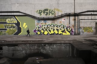 An urban explorer (urbex) scouts an abandoned steel plant in Charleroi, southern Belgium, on March 11, 2026.