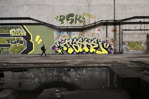 An urban explorer (urbex) scouts an abandoned steel plant in Charleroi, southern Belgium, on March 11, 2026.