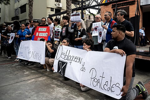 Human rights activists and members of the National Journalists Association of Venezuela take part in a demonstration to demand unblocking restricted websites in front of the National Commission of Telecommunications (Conatel) headquarters in Caracas on March 13, 2026.
