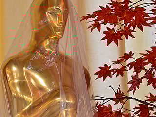 A decorative replica Oscar statue covered in protective plastic sheeting is seen as preparations are made on the red carpet arrivals area ahead of the 98th Annual Academy Awards in Hollywood, California, on March 13, 2026. 