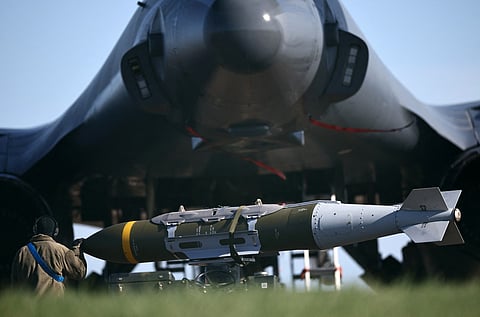 USAF military ground personnel prepare Joint Direct Attack Munitions (JDAM) for a US Air Force (USAF) B-1 Lancer bomber jet on the tarmac the tarmac at RAF Fairford in south-west England on March 14, 2026.