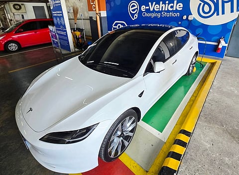 Filipino businessman Glenn Cuarto, a former OFW from the UAE, charges his Tesla Model 3 at a local mall (SM City). 