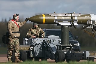 US Military personnel take away Joint Direct Attack Munitions (JDAMs), removed from a US Air Force B-1 Lancer bomber at RAF Fairford in south-west England on March 15, 2026.