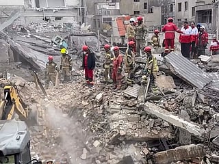 Members of the Iranian Red Crescent and Iranian firefighters searching the rubble of a collapsed building following a reported military strike in an undisclosed location in Iran. Iranian Red Crescent