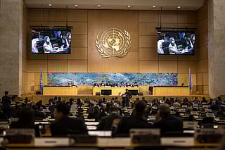 A Gulf representative is seen on screens as he delivers a speech on human rights in the Islamic Republic of Iran during a session of the UN Human Rights Council, in Geneva on March 16, 2026.