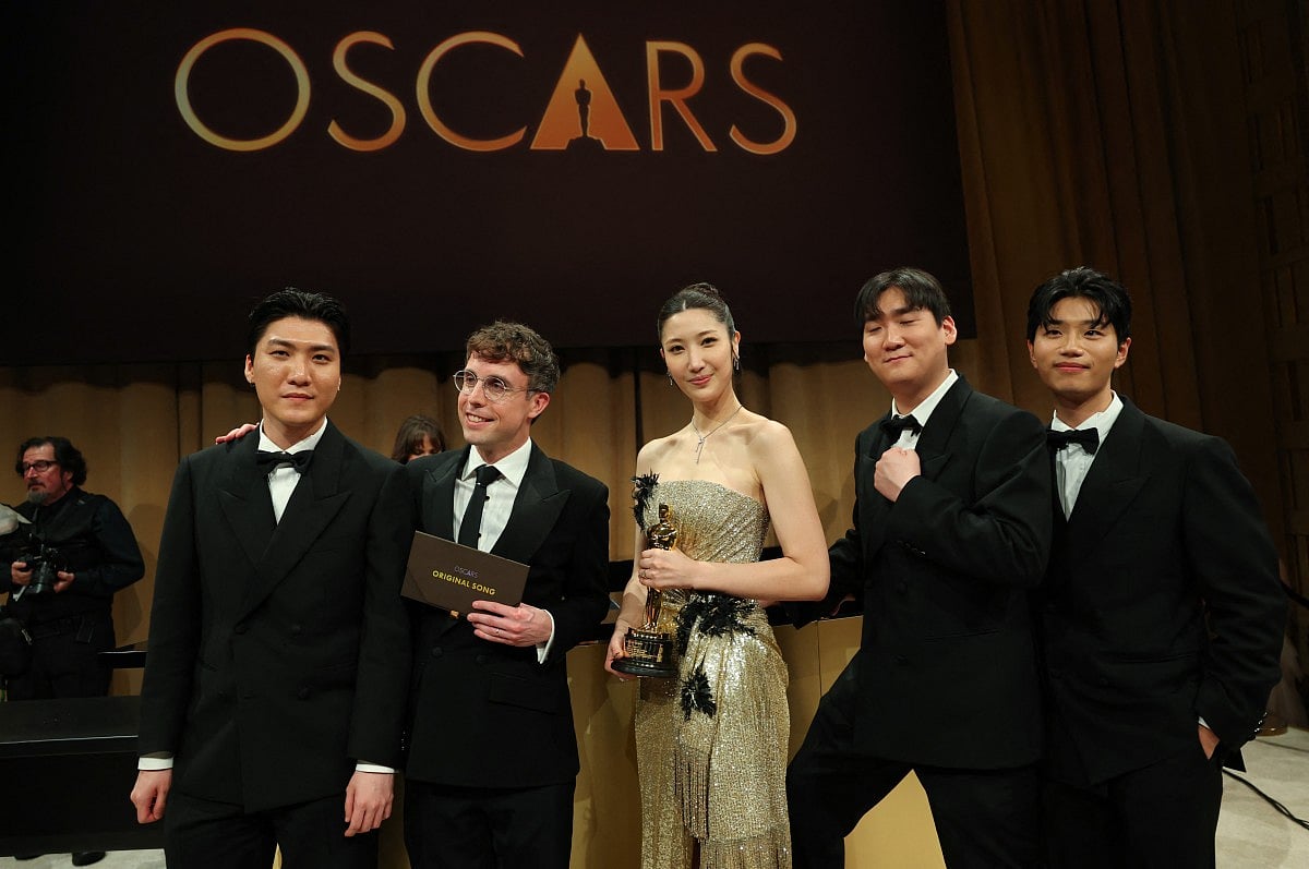 South Korean-US singer Ejae holds the Oscar for Best Music (Original Song) for "Golden" from "KPop Demon Hunters" with Jeong Hoon Seo (L), US songwriter Mark Sonnenblick (2L), Hee Dong Nam (2R) and Yu Han Lee (L) during the 98th Annual Academy Awards Governors Ball at the Dolby Theatre in Hollywood, California on March 15, 2026.