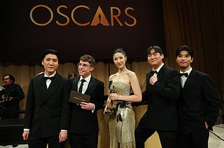 South Korean-US singer Ejae holds the Oscar for Best Music (Original Song) for "Golden" from "KPop Demon Hunters" with Jeong Hoon Seo (L), US songwriter Mark Sonnenblick (2L), Hee Dong Nam (2R) and Yu Han Lee (L) during the 98th Annual Academy Awards Governors Ball at the Dolby Theatre in Hollywood, California on March 15, 2026.