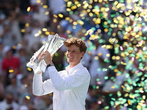 Jannik Sinner of Italy hoists the championship trophy after defeating Daniil Medvedev during their Men's Singles Finals match at the BNP Paribas Open at Indian Wells Tennis Garden