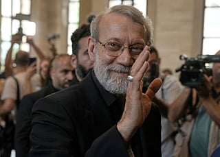 FILE - Iranian Secretary of Supreme National Security Council Ali Larijani, greets journalists upon his arrival to meet with the Lebanese parliament speaker Nabih Berri, in Beirut, Lebanon, Wednesday, Aug. 13, 2025. (AP Photo/Bilal Hussein, File)