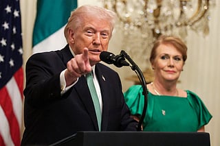 President Donald Trump speaks alongside Taoiseach of Ireland Micheál Martin's wife Mary O'Shea during a St. Patrick’s Day event in the East Room of the White House on March 17, 2026 in Washington, DC. The Shamrock Bowl presentation is an annual St. Patrick's Day tradition symbolizing U.S.-Irish relations.