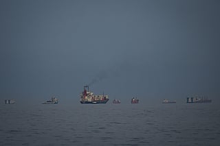Oil tankers and cargo ships line up in the Strait of Hormuz as seen from Khor Fakkan, United Arab Emirates, Wednesday, March 11, 2026. (AP Photo/Altaf Qadri)