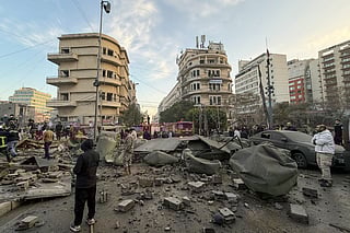 People gather at the site of an Israeli airstrike in Beirut's Bashoura neighborhood on March 18, 2026.