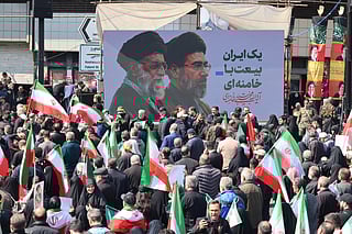 Mourners participate in a procession during the funeral of Iran’s national security chief Ali Larijani, Basij commander Gholamreza Soleimani and Iranian sailors killed in recent strikes, in Tehran on March 18, 2026.