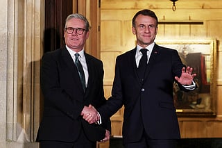 FILE - British Prime Minister Keir Starmer, left, and French President Emmanuel Macron shake hands ahead of a bilateral meeting at Chequers, near Aylesbury, England, Jan. 9, 2025. (Toby Melville/Pool Photo via AP, File)