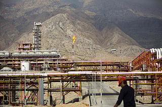 An Iranian walks along the phase 15-16 of the South Pars gas field facilities in the southern Iranian port of Assaluyeh on the shore of the Gulf.