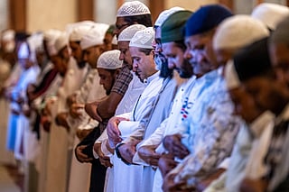 Muslim devotees attend the morning prayers celebrating the holiday of Eid al-Fitr, marking the end of the holy month of Ramadan, at the Mary Mother of Jesus Mosque in Abu Dhabi early on March 20, 2026.