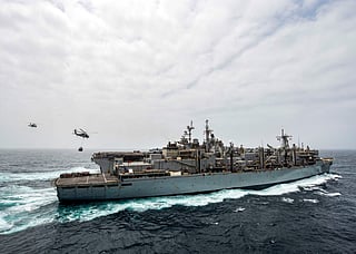 This handout picture released by the US Navy on July 14, 2019 shows the amphibious assault ship USS Boxer (LHD 4) receiving a vertical replenishment-at-sea from the fast combat support ship USNS Arctic (T-AOE 8) in the Arabian Sea.