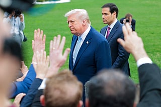 President Donald Trump and U.S. Secretary of State Marco Rubio (R) stop to speak to reporters as he departs the White House on March 20, 2026 in Washington, DC. President Trump is traveling to Florida to spend the weekend at his Mar-a-Lago resort.