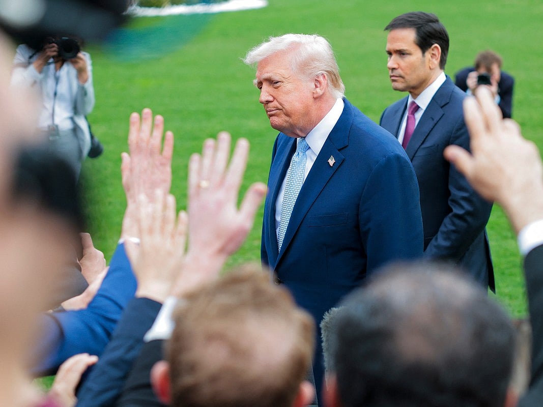 President Donald Trump and US Secretary of State Marco Rubio (R) stop to speak to reporters as he departs the White House on March 20 in Washington, DC.