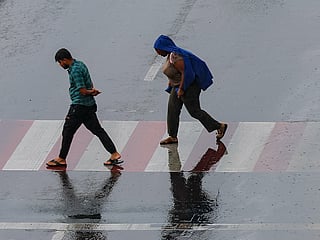 Residents caught in the rain at Al Majaz in Sharjah. 