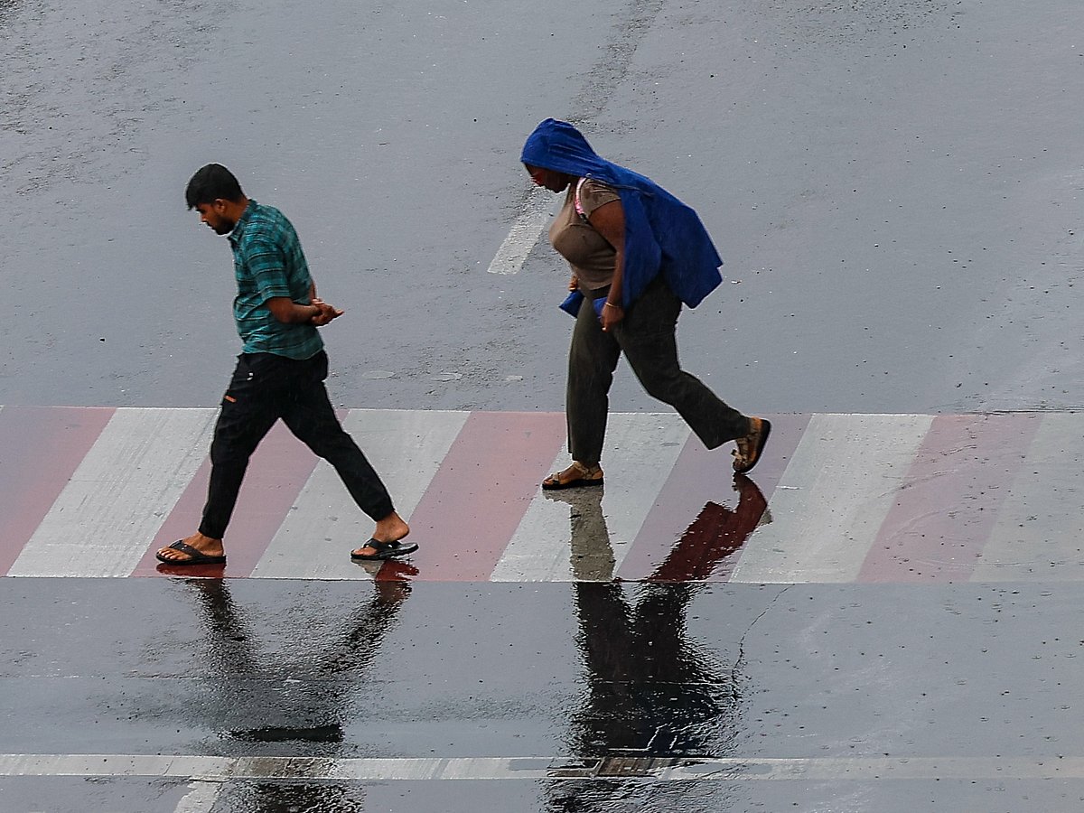 Residents caught in the rain at Al Majaz in Sharjah. 