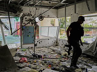 An Israeli policeman walks in a kindergarten hit by fragments of an Iranian missile in Rishon LeZion, Israel, on Saturday, March 21, 2026. 