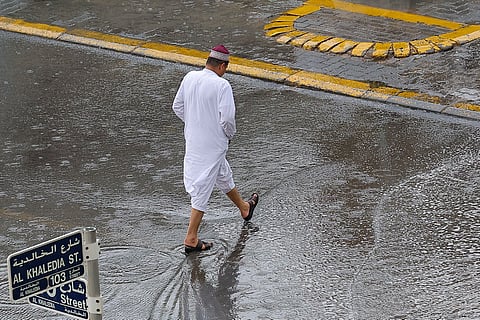 Residents brave the rain at Al Majaz, Sharjah. Photo: Virendra Saklani/Gulf News