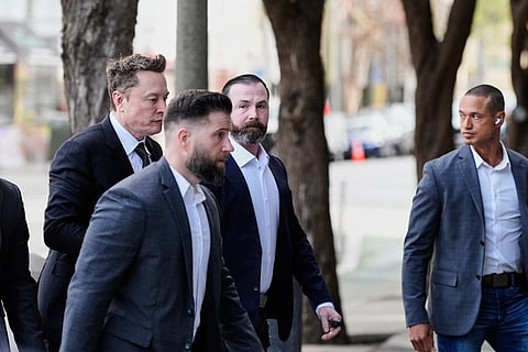 Elon Musk, left, arrives for a Twitter shareholder trial at the U.S. District Court for the Northern District of California, Wednesday, March 4, 2026, in San Francisco. (AP Photo/Godofredo A. Vásquez)
