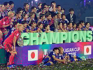 Japan's Maika Hamano celebrates with the trophy after winning the Women's Asian Cup soccer final against Australia in Sydney, Saturday, March 21, 2026. 