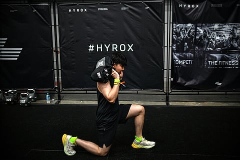 A participant warms up before competing in the Hyrox fitness race at the Bangkok International Trade and Exhibition Centre (BITEC) in Bangkok on March 21, 2026.