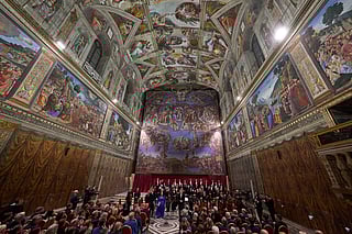 Conductor Harry Christopher, center, with tenor Matthew McKinney, left, soprano Elizabeth Watts, second from left, and The Sixteen present Angels Unawares by James MacMillan in the Sistine Chapel at the Vatican, Sunday, March 22, 2026. (AP Photo/Domenico Stinellis)