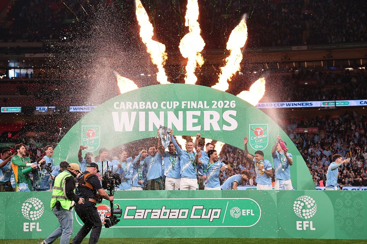 Manchester City's players celebrate with the trophy after the English League Cup final football match between Arsenal and Manchester City at Wembley Stadium in London on March 22, 2026.