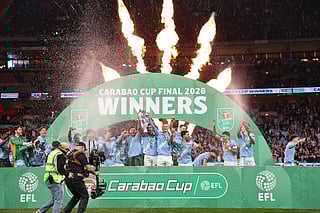 Manchester City's players celebrate with the trophy after the English League Cup final football match between Arsenal and Manchester City at Wembley Stadium in London on March 22, 2026.