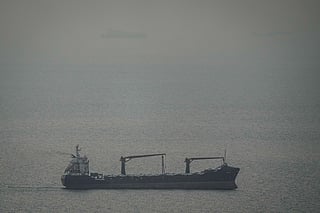 A cargo ship carrying vehicles sails through the Arabian Gulf toward the Strait of Hormuz in the United Arab Emirates, Sunday, March 22, 2026. (AP Photo)