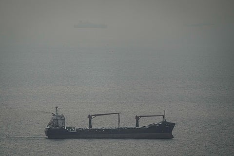 A cargo ship carrying vehicles sails through the Arabian Gulf toward the Strait of Hormuz in the United Arab Emirates, Sunday, March 22, 2026. (AP Photo)