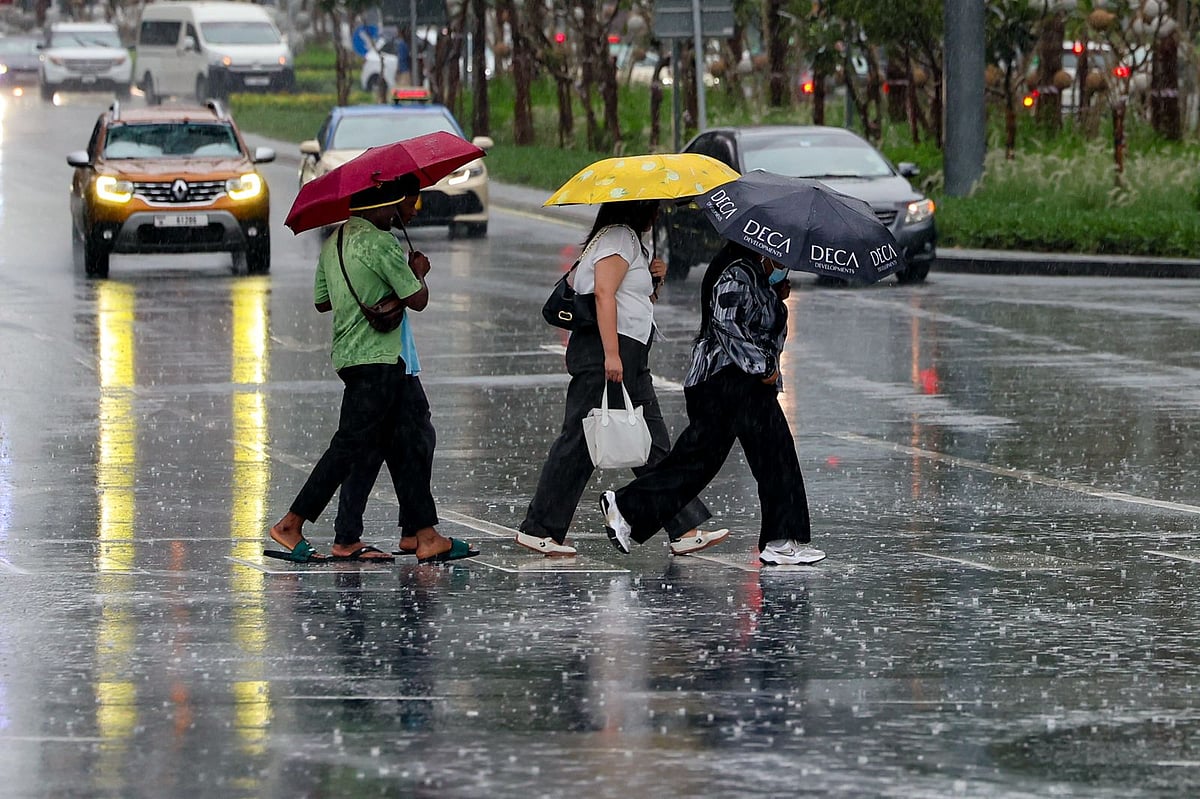 Residents navigate heavy rain in Dubai’s Business Bay on Monday.
