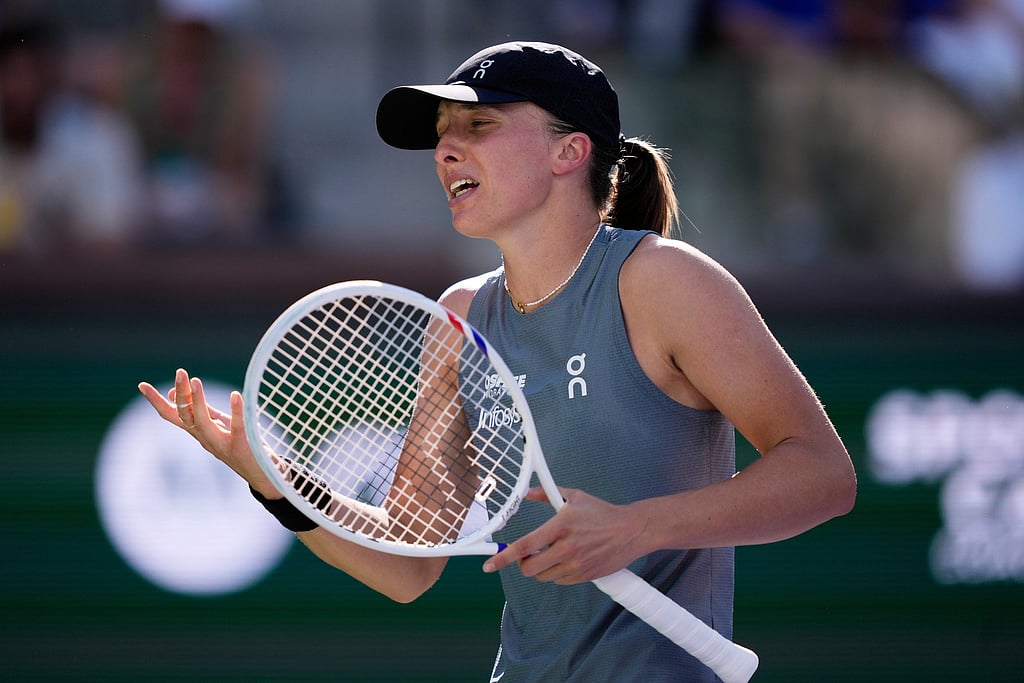 Iga Swiatek, of Poland, reacts after losing a point against Elina Svitolina, of Ukraine, during a quarterfinal match at the BNP Paribas Open tennis tournament, Thursday, March 12, 2026, in Indian Wells, Calif.